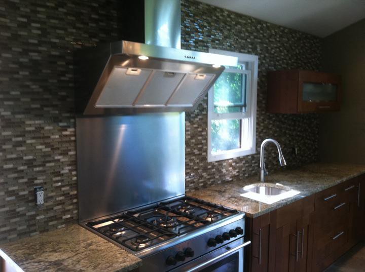 Kitchen backsplash and granite countertop by Tiled to Perfection
